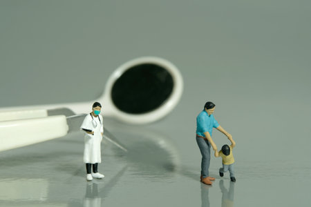Miniature people toy figure photography. Refusing go to dentist women checking teeth concept. A father and son standing in front of dentist tool equipment. Image photoの写真素材