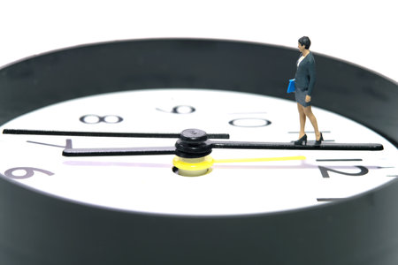 Miniature people toy figure photography. A businesswoman walking above clockwise. Isolated on white background. Image photoの写真素材