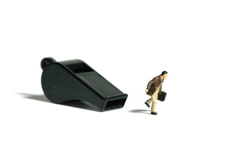 Miniature people toy figure photography. Whistle blower concept illustration. A businessman running in front of black whistle, isolated on white background. Image photoの写真素材