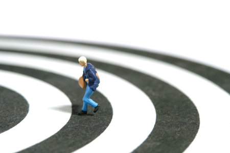 Miniature tiny people toy figure photography. A women college student running above line track...