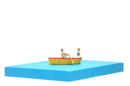 Creative miniature people toy figure photography. Sticky notes installation. A couple dating on a...