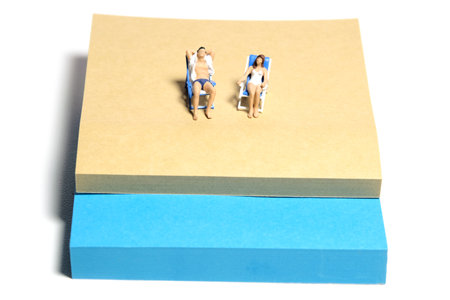 Creative miniature people toy figure photography. Sticky notes installation. A couple chilling out...