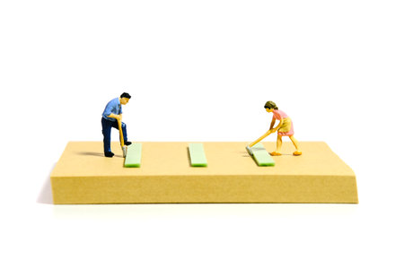 Creative miniature people toy figure photography. Sticky notes installation. A couple doing gardening activity at yard on summer holiday. Isolated on white background. Image photoの写真素材