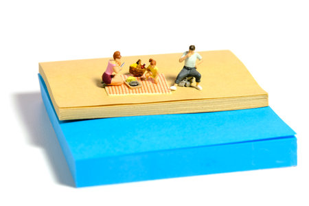 Creative miniature people toy figure photography. Sticky notes installation. Family picnic time at river on summer holiday. Isolated on white background. Image photoの写真素材