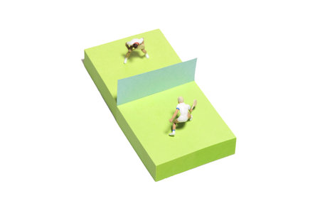Creative miniature people toy figure photography. Sticky notes installation. Men's singles badminton, tennis ball match. Isolated on white background. Image photoの写真素材