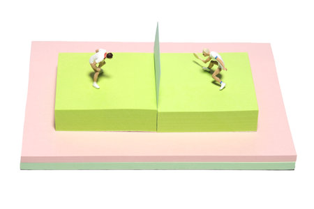 Creative miniature people toy figure photography. Sticky notes installation. men's singles badminton, tennis ball match at court field. Isolated on white background. Image photoの写真素材