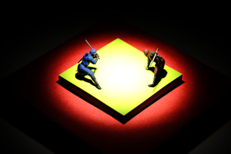 Creative miniature people toy figure photography. Sticky notes installation. Two ninja fighting on red mat arena. Image photoの写真素材