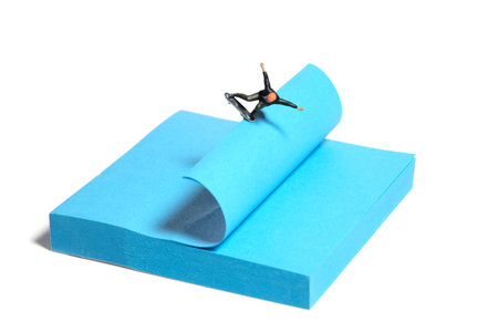 Creative miniature people toy figure photography. Sticky notes installation. A men skater playing skateboarding sport at skate park. Isolated on white background. Image photoの写真素材