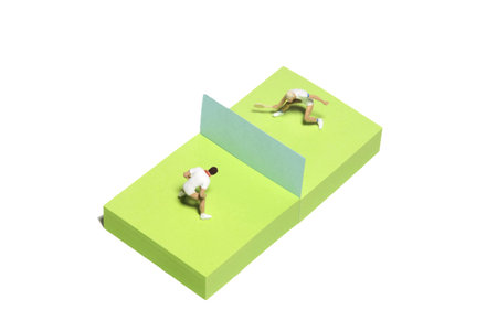 Creative miniature people toy figure photography. Sticky notes installation. Men's singles badminton, tennis ball match. Isolated on white background. Image photoの写真素材