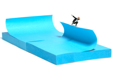 Creative miniature people toy figure photography. Sticky notes installation. A boy skater playing skateboarding sport at skate park. Isolated on white background. Image photoの写真素材