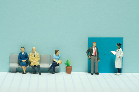 Miniature tiny people toy figure photography. A waiting line in hospital of patient to meet the doctor for medical health check. Image photoの写真素材