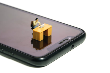 Miniature tiny people toy figure photography. Work from anywhere, mobile worker concept. A...