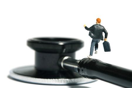 Miniature people toy figure photography. A boy pupil student running above stethoscope. Isolated on white background. Image photoの写真素材
