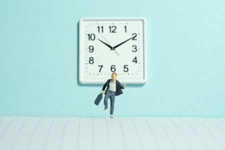Miniature tiny people toy photography. A boy pupil student running in the school hallway, late for class. Image photoの写真素材