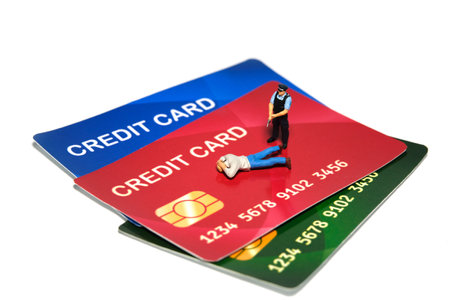 Miniature people toy figure photography. A policeman catches credit card fraudsters. Isolated on white background. Image photoの写真素材
