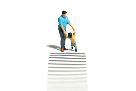 Miniature people toy figure photography. Learning road traffic sign concept. A father and son walking on crosswalk. Isolated white background. Image photoの写真素材