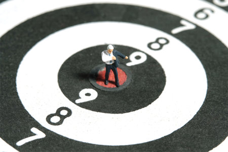 Miniature tiny people toy figure photography. Top view. A businessman getting ready wearing suit in...