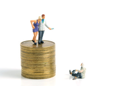 Miniature tiny people toys photography. a generous man standing on a pile of coins, giving money to a man, isolated on white background. Image photoの写真素材