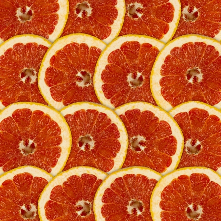 Abstract red background with citrus-fruit of grapefruit slicesの写真素材
