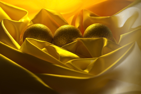 Christmas balls decoration on a yellow satin clothの写真素材