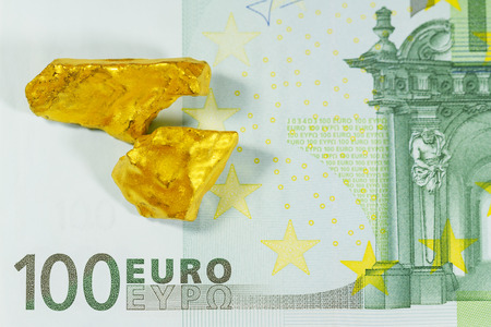 Golden nuggets on euro banknotes close upの写真素材