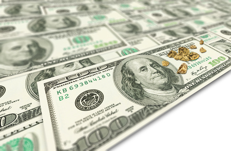 Golden nuggets on one hundred dollars banknotes blured with soft focus