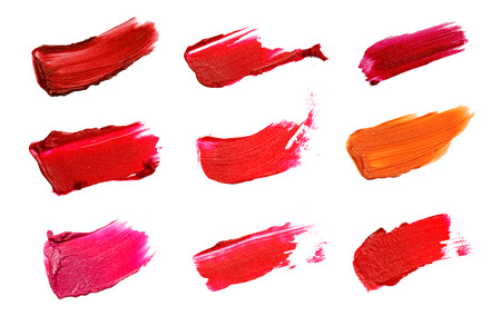 Collage of decorative cosmetics  color brush lipstick strokes on white background. Beauty and makeup concept.の写真素材