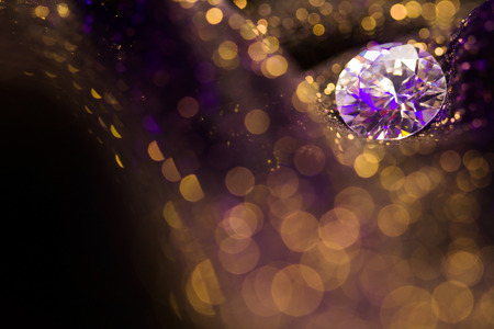 Amazing glitter and glow soft multi colored bokeh shining with big natural jewelry precious stone. Dark abstract dreamy wunderful sparkle backgroundの写真素材
