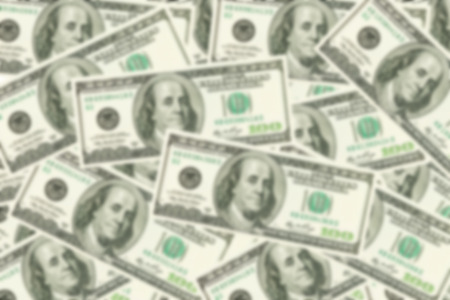 Blured background of one hundred dollars banknotes