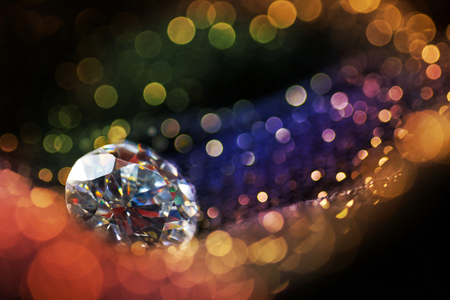 Glitter and glow soft multi colored  bokeh shining with big natural jewelry precious stone. Dark abstract dreamy wunderful sparkle backgroundの写真素材