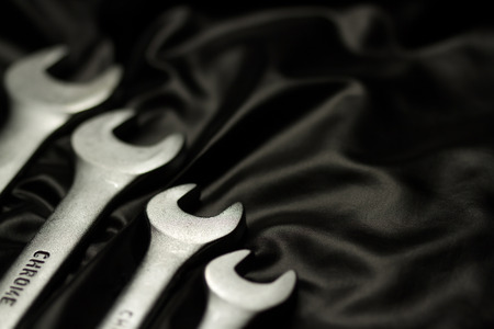 Set of wrenches on black background
