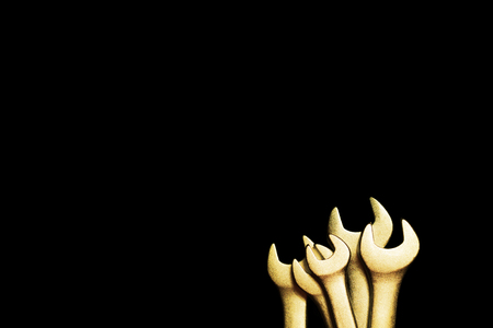 Golden wrenches on black backgroundの写真素材