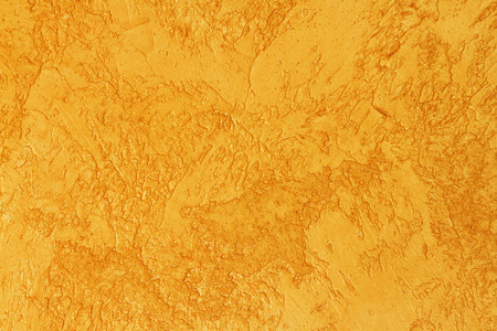 Background of golden textured surface. Golden texture for design and web background. Shiny golden surface of concrete wall.の写真素材