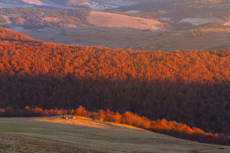 Tourist camp in a mountains with beautiful sunrise. Beauty world of mountains with red sunlight beams on forest.  Carpathian, Ukraine, Europe.の写真素材