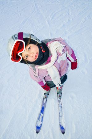 girl in ski gear looking upwards at a ski resort in Finlandの写真素材
