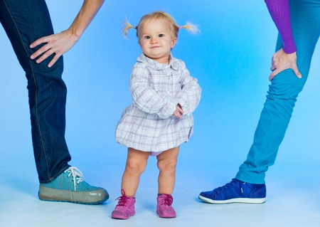 Cute baby Girl In Fashionable Outfit with parents