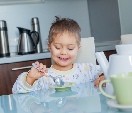 Happy Boy Eating Breakfastの写真素材