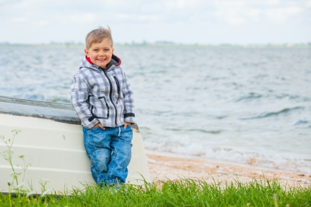 Boy Sitting on the boatの写真素材