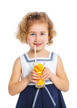 Portrait of little girl drinking orange juiceの写真素材
