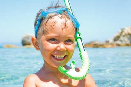 Cute boy playing in the seaの写真素材