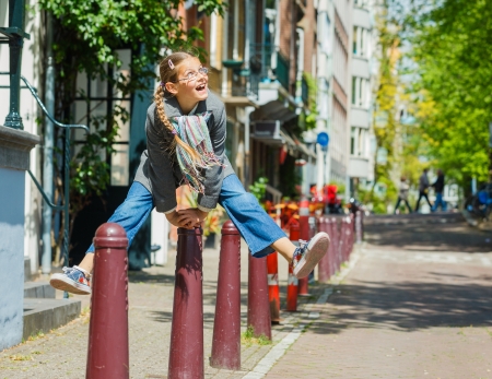 Happy pretty girl walking outdoors in Amsterdamの写真素材