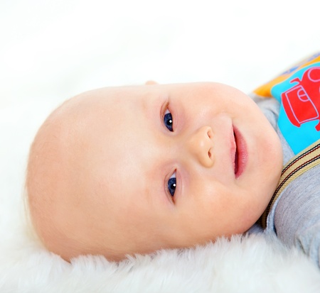 Closeup portrait of cute baby boy on white background 
