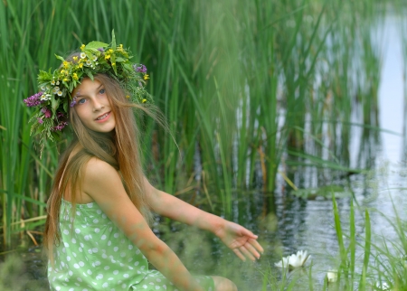 Spring portrait beautiful girl with wreath of flowersの写真素材