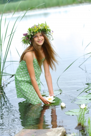 Spring portrait beautiful girl with wreath of flowers  Vertical viewの写真素材