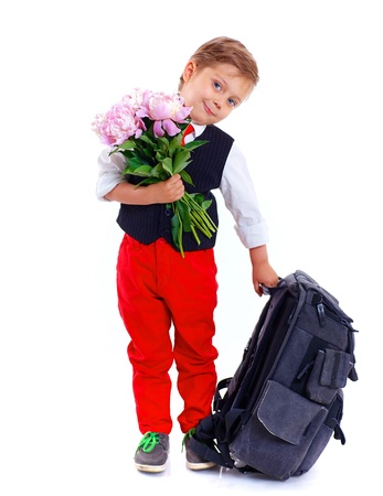 Happy schoolboy with flower and backpack isolated on white backgroundの写真素材