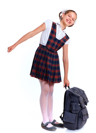 Joyful schoolgirl smiling happily with heavy backpack  Isolated on white backgroundの写真素材