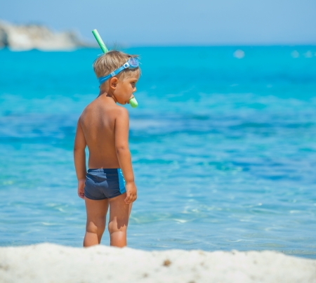 Back view of cute boy snorkelling ready swim in the transparent sea の写真素材