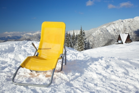 Concept of relax  Chair on top of mountain range at winter season sunny day with blue skyの写真素材