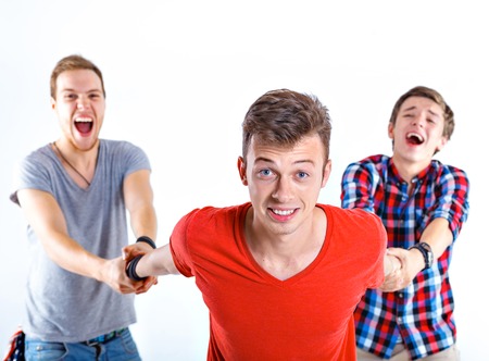 Portrait of young happy smiling teenager boy with his friends  Isolated on white background 