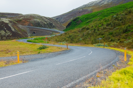 Highway through Iceland landscape at foggy day  Horizontal shot
